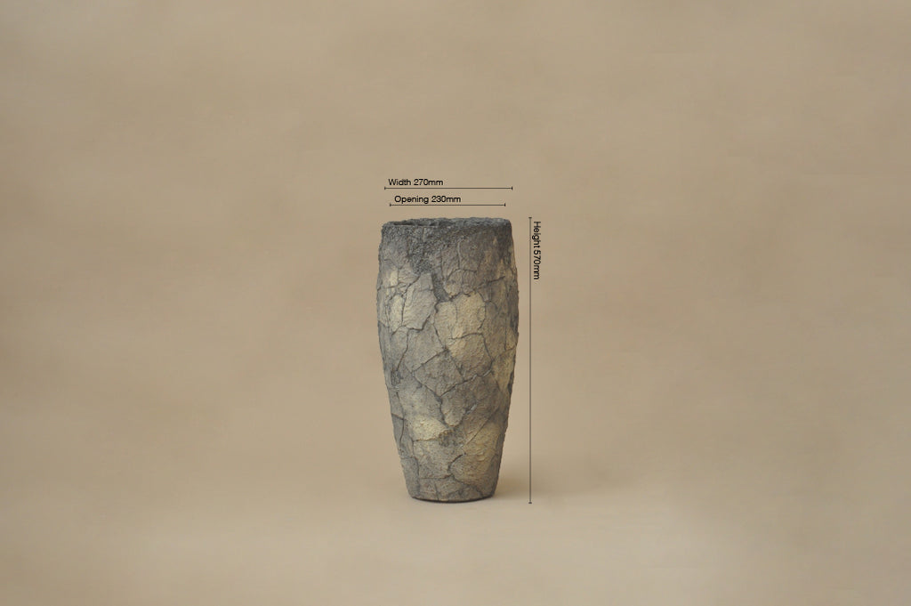 Cylindrical stone object with measurement labels on a beige background