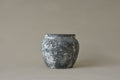 Black textured vase on a beige background