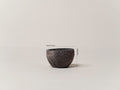 Small luxury plant pot in dark natural volcanic stone with a textured finish, suitable for indoor and outdoor use.